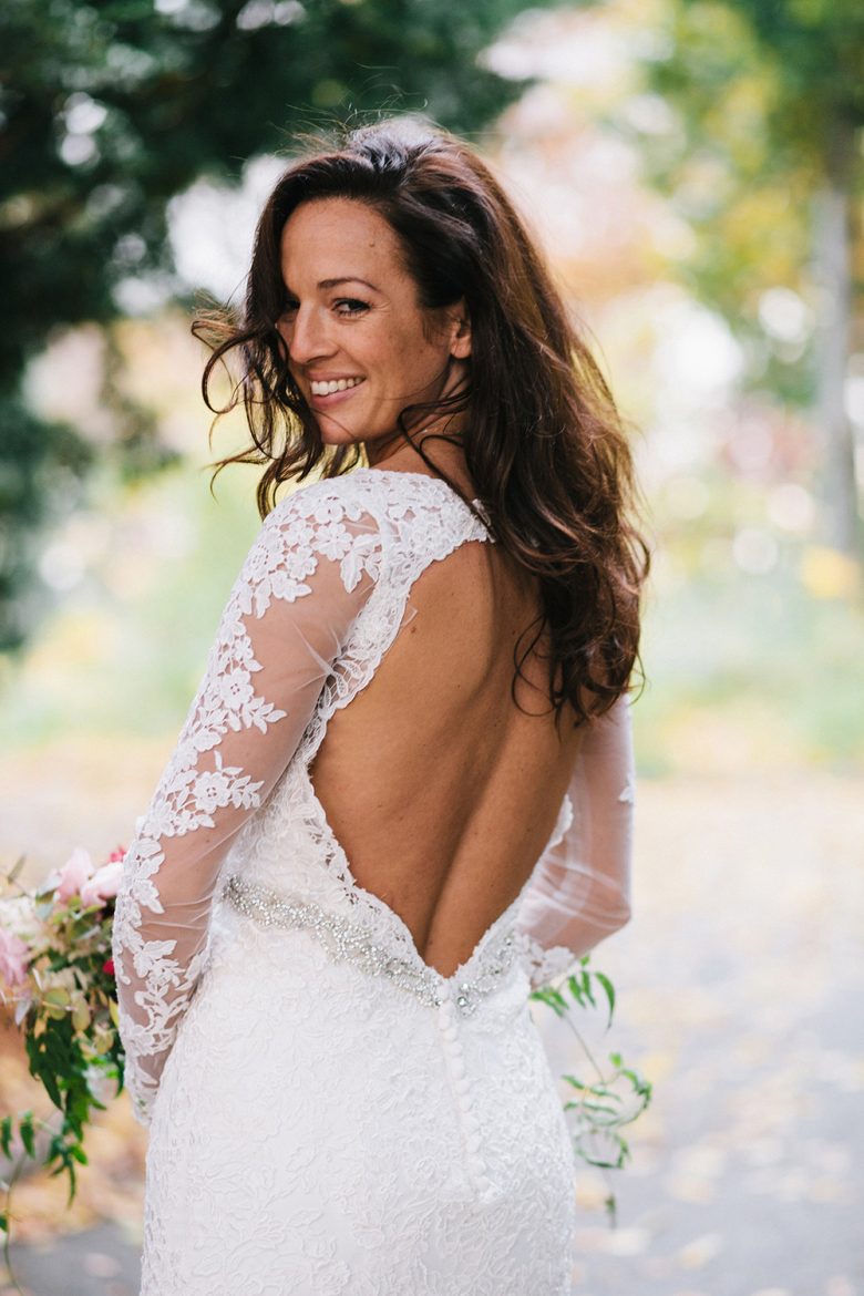 smiling bride in long sleeved lace dress