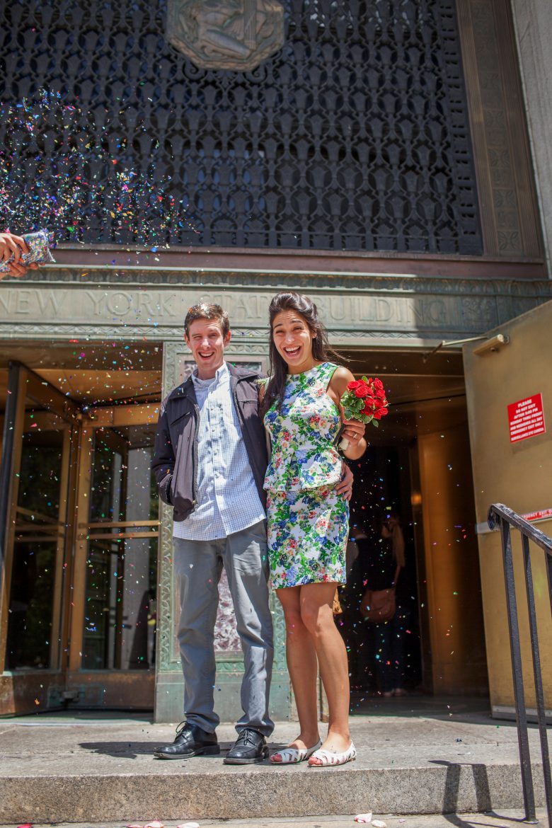 couple showered with confetti on steps of New York City Hall
