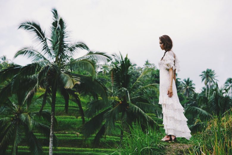 model standing in rice paddies