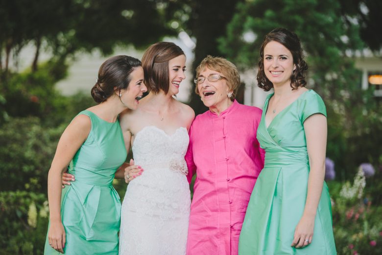 bride with bridesmaids in green and grandmother in hot pink