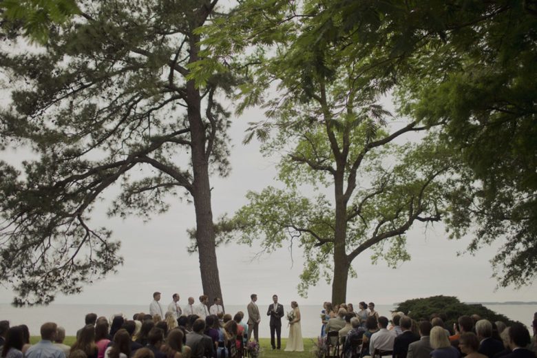 waterfront wedding ceremony under trees