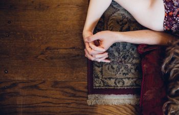 couple holding hands on a rug