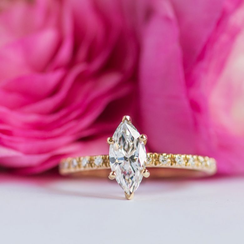 yellow gold french cut pave engagement ring nestled in roses