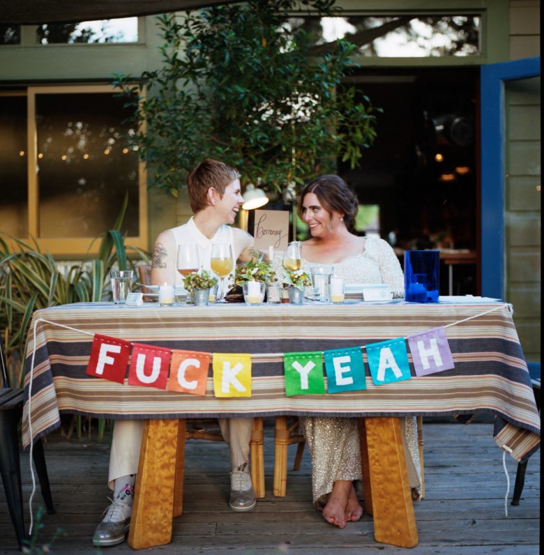 couple at table with fuck yeah bunting