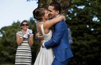 bride and groom laughing after their kiss