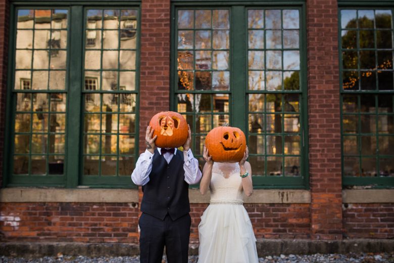 bride and groom holding jack o lanterns