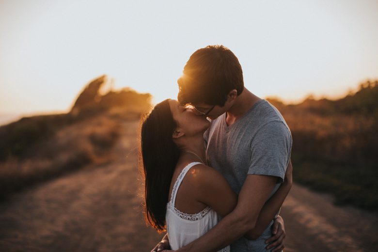 couple kissing each other at sunset