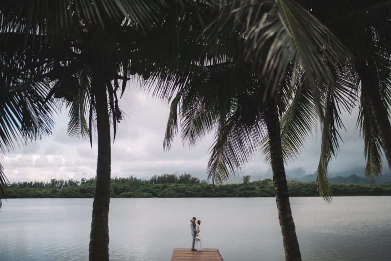 wide shot of couple standing on a dock