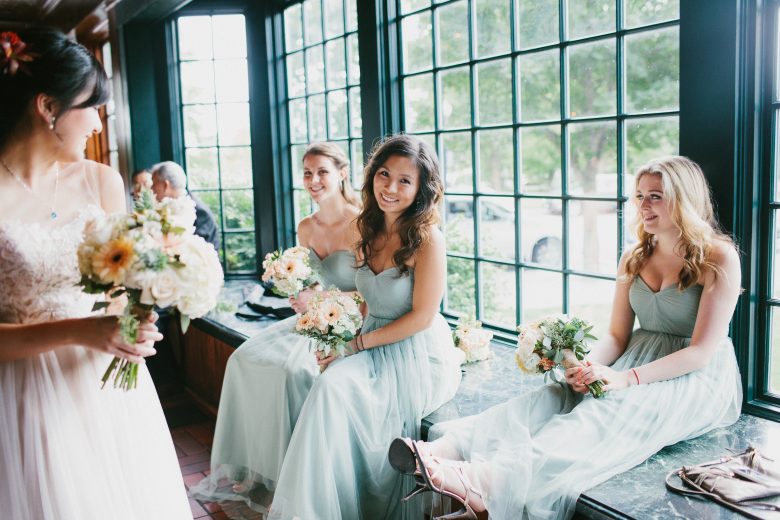 bridesmaids sitting together by a window