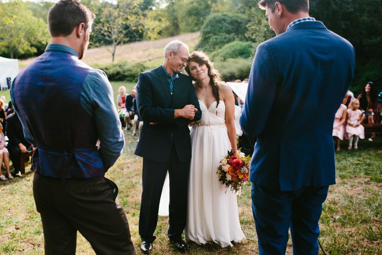 bride standing with her dad during wedding