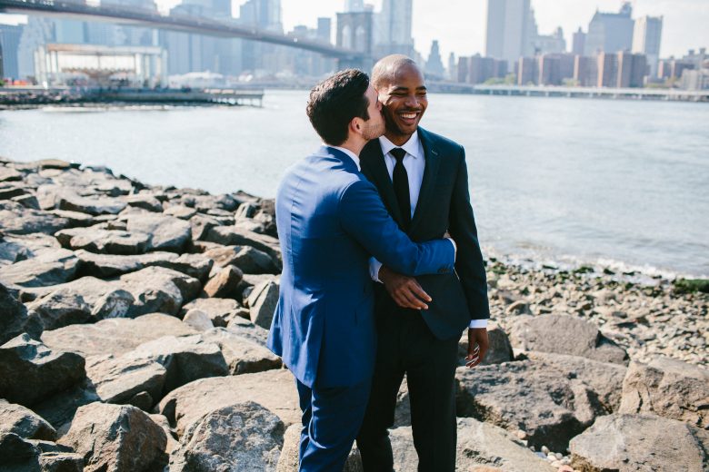 two grooms laughing togeteher