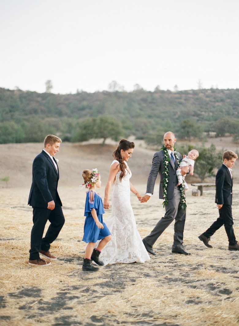blended family walking together at wedding