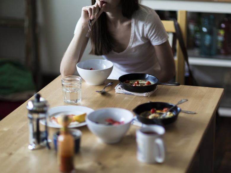 woman eating breakfast alone