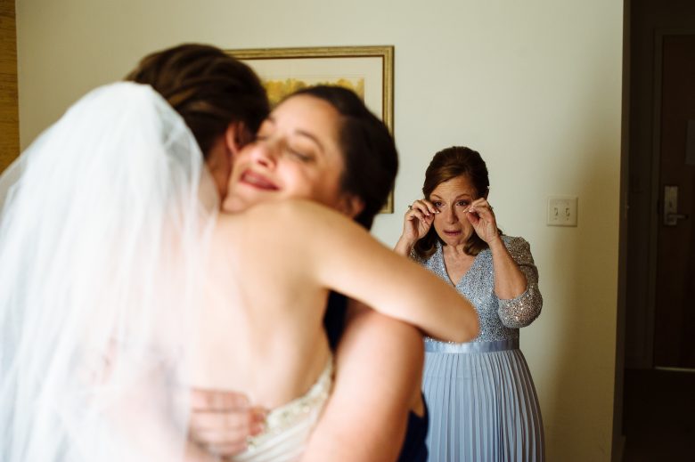 mother crying when seeing daughter at wedding