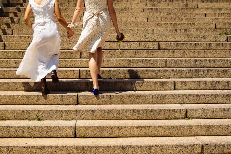 two brides walking up stairs