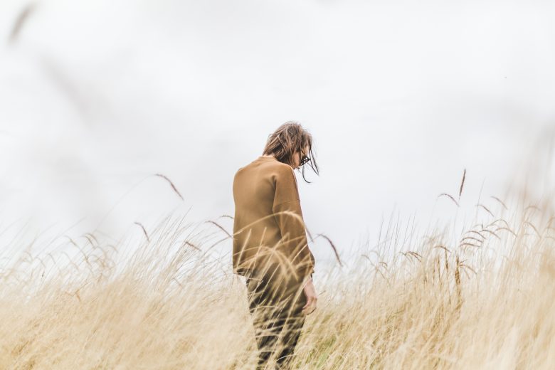 woman standing alone in a field