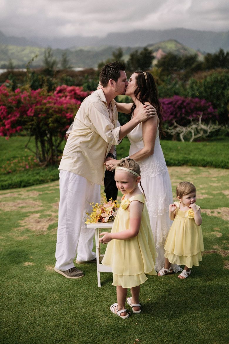 a couple and their daughters at their wedding in hawaii