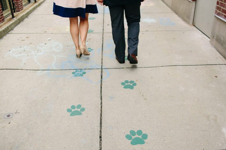 man and woman walking down a sidewalk