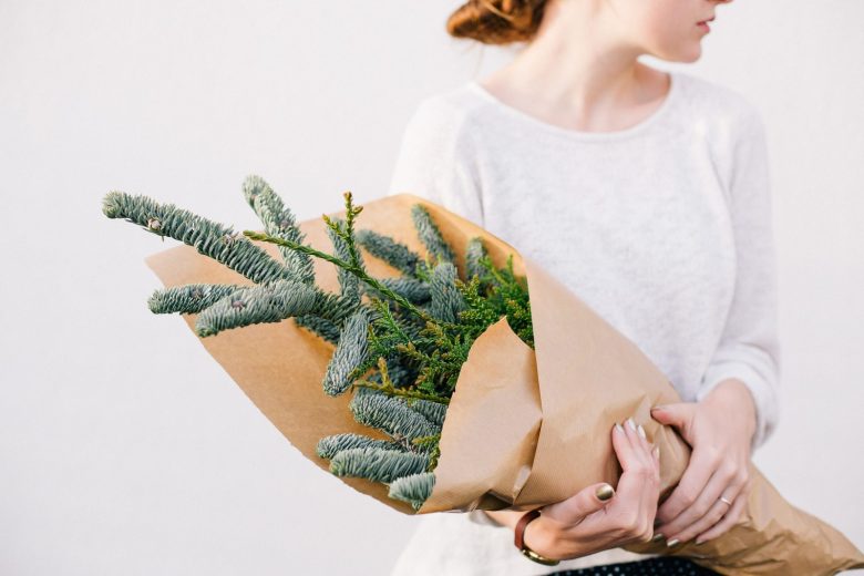 woman holding holiday plants