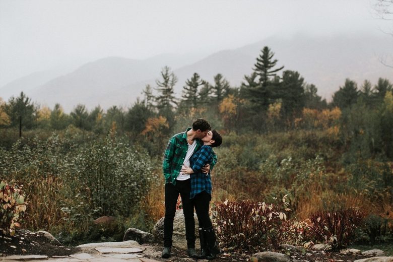 a couple kissing in the forest