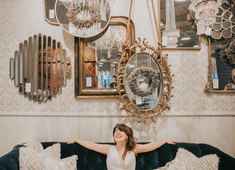 Bride wearing BHLDN Lily gown on blue anthropologie velvet couch