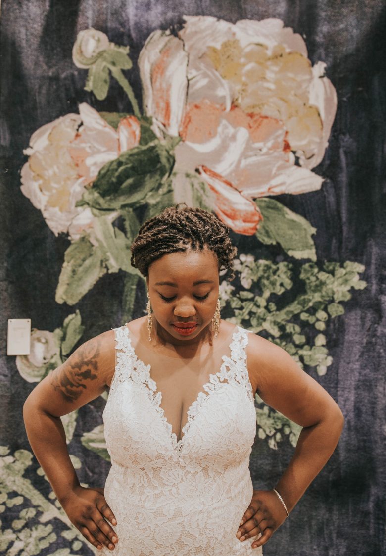 black plus size bride wearing BHLDN Carson gown in the Palo Alto Anthropologie store