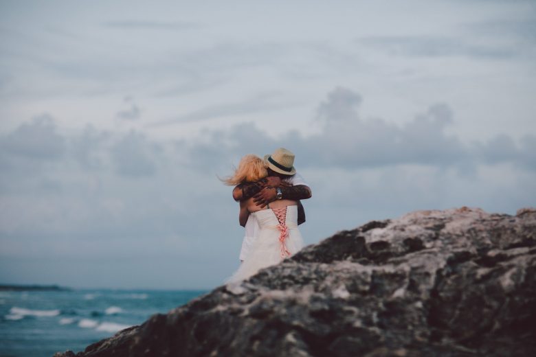 couple hugging near the ocean