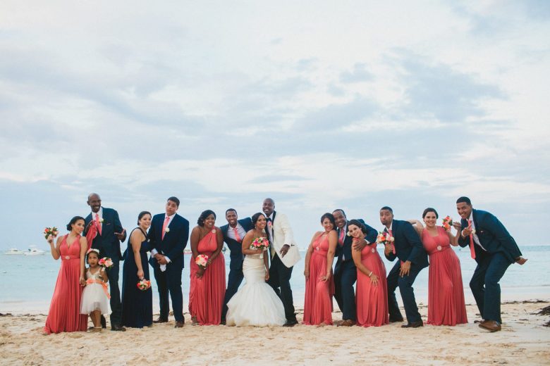 wedding party on beach in coral dresses