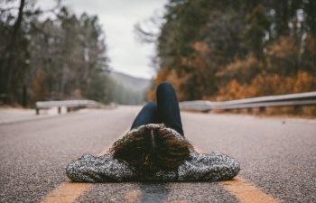 woman laying in the road