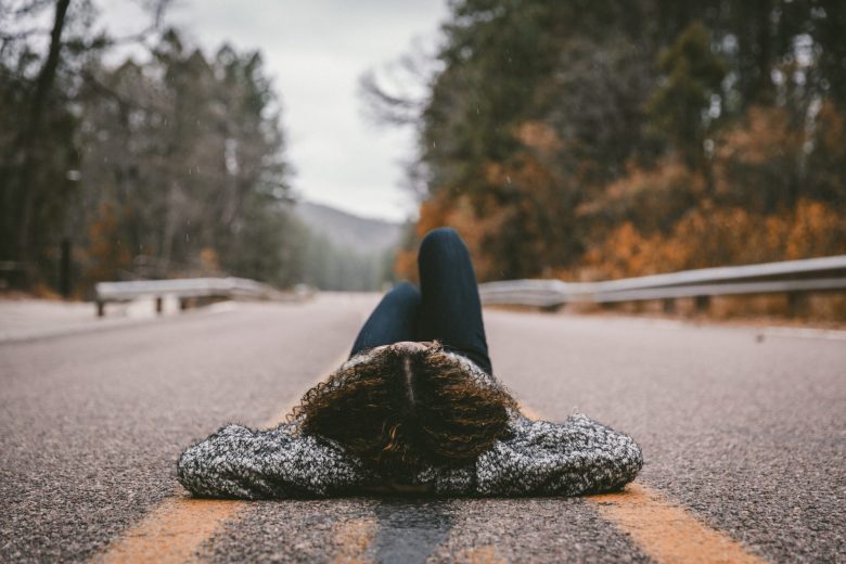 woman laying in the road