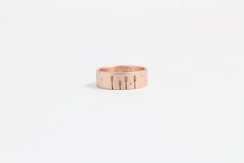 wedding ring from ash hilton with etched pine trees and inset small diamonds