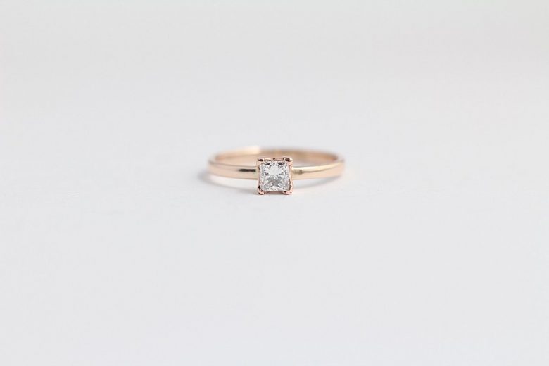 wedding ring from ash hilton with a rose gold band and square solitaire diamond