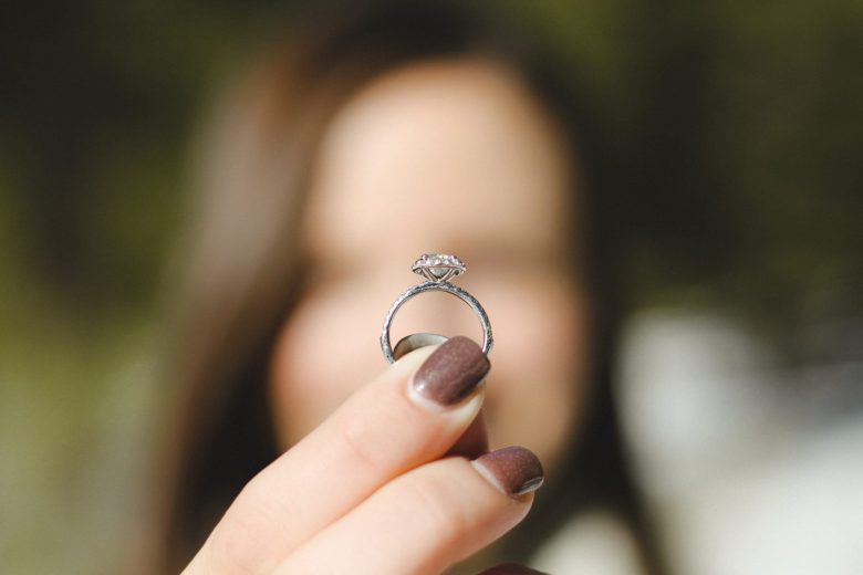 woman holding a engagement ring