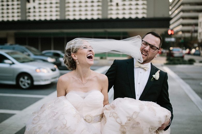 a couple laughing on their wedding day