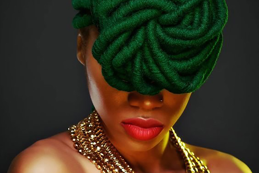 eye covering updo with green locs