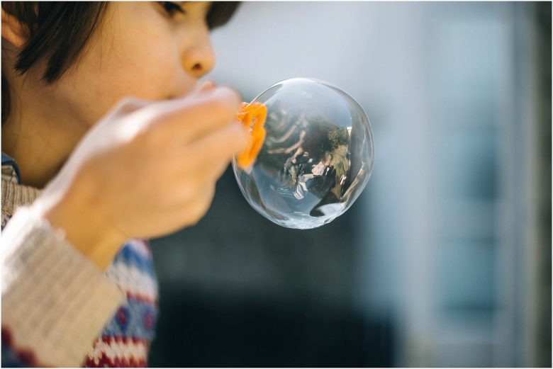 kid blowing bubbles