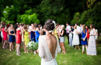 bride standing in front of wedding group