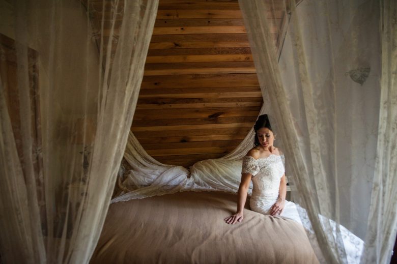 a bride sitting on a bed