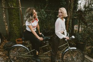 two women riding a bike together