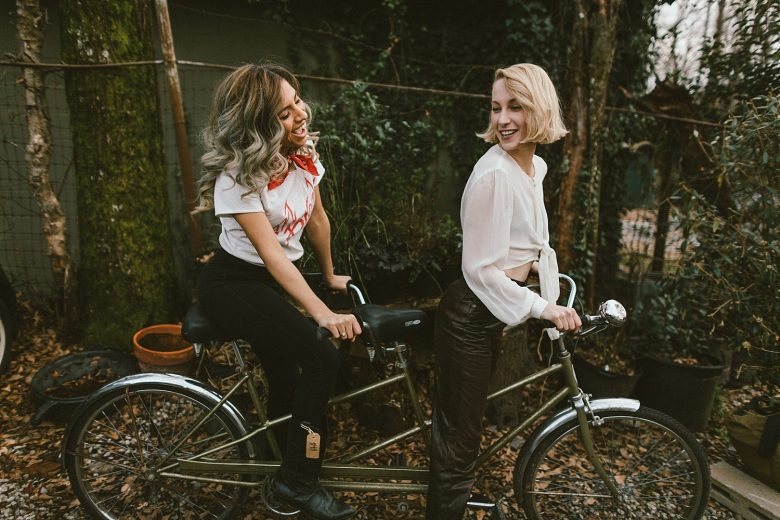 two women riding a bike together