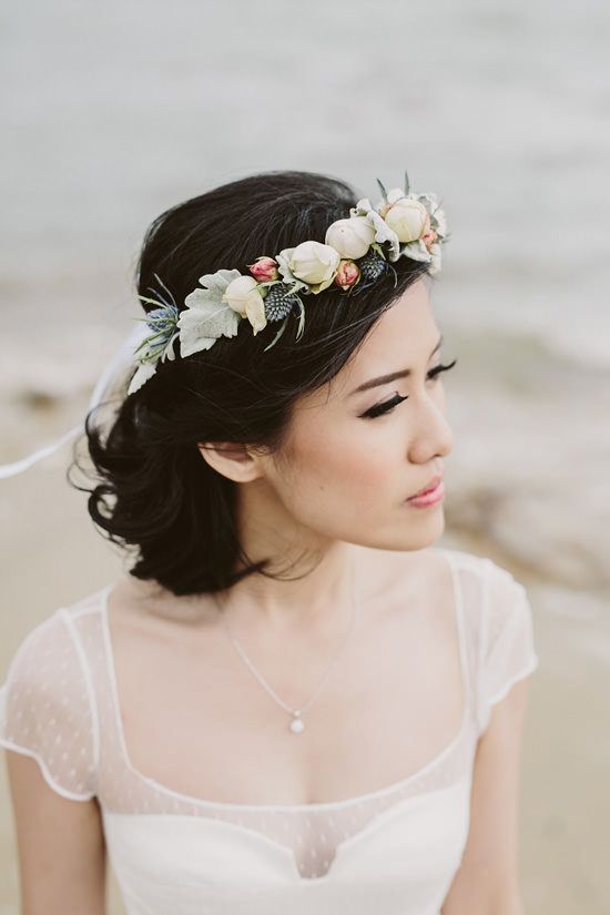a bride looks off towards the distance while her flower crown blows gently in the wind
