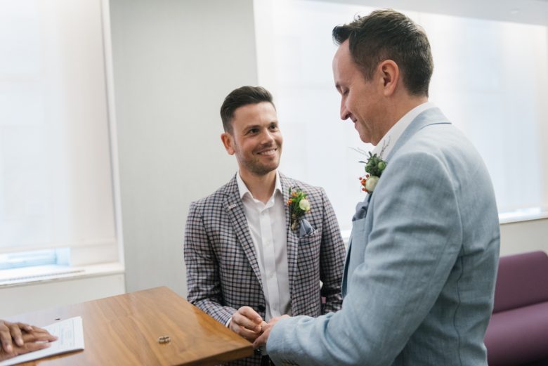two grooms exchanging rings at New York City Hall