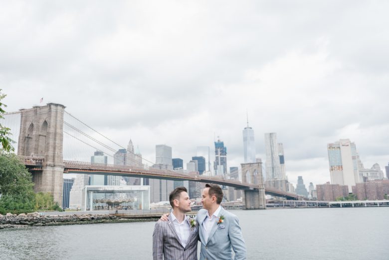 two grooms in front of the Brooklyn Bridge