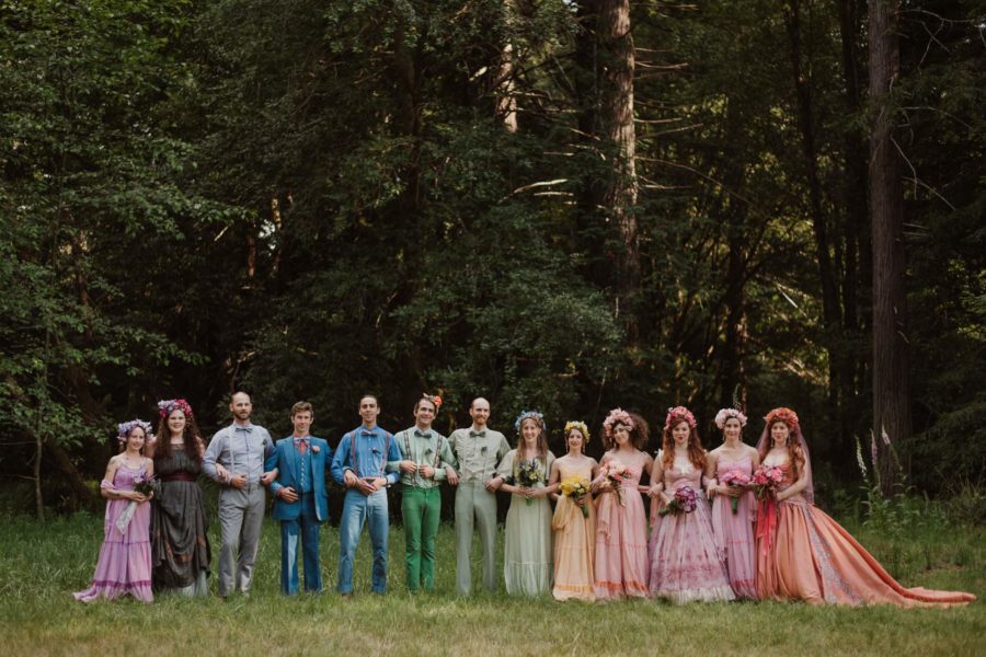 A wedding party all wearing colored wedding dresses