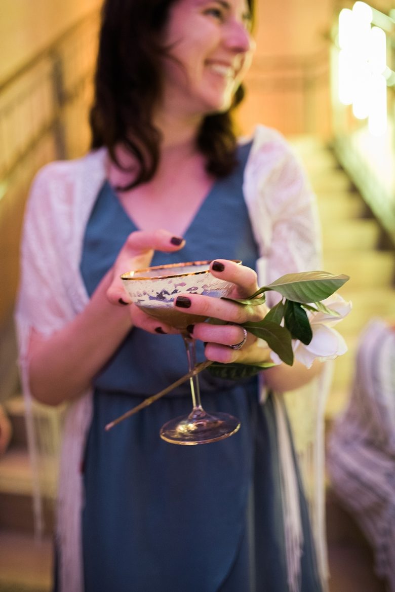 a woman holding a drink at the cream event 2017