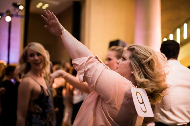 a woman dancing at a wedding event