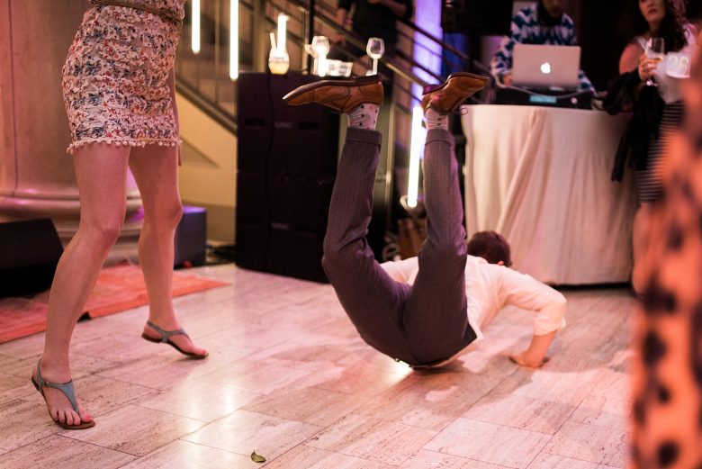 a man dancing on the floor of a wedding event