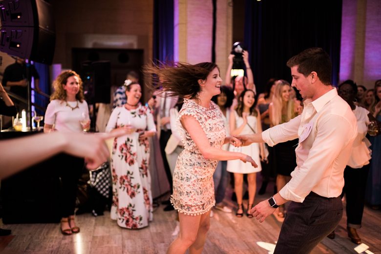 two people dancing at a wedding event