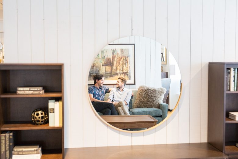 Author and his partner reflected in Gerald Round Wall Mirror above HD Media Console with Towers at Crate and Barrel
