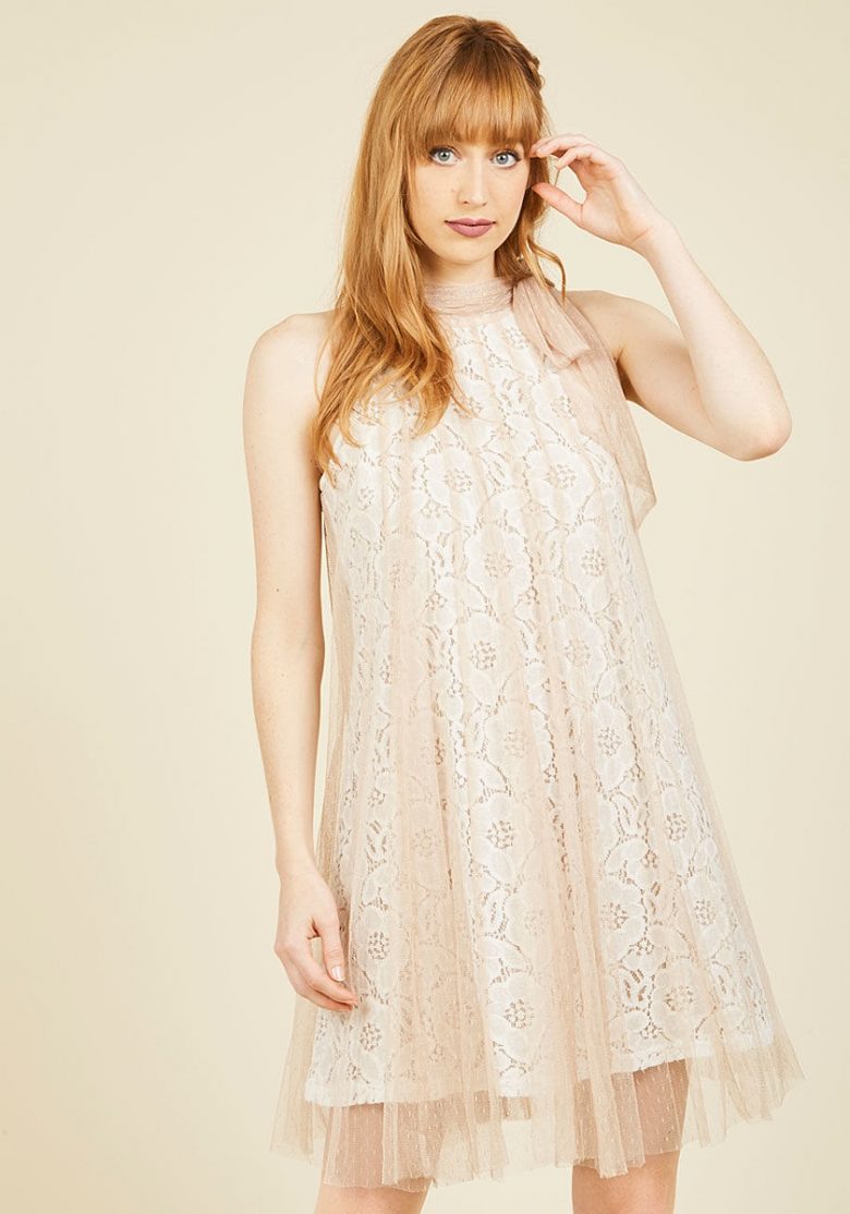 Lace shift high neck dress on redhead woman with tulle overlay
